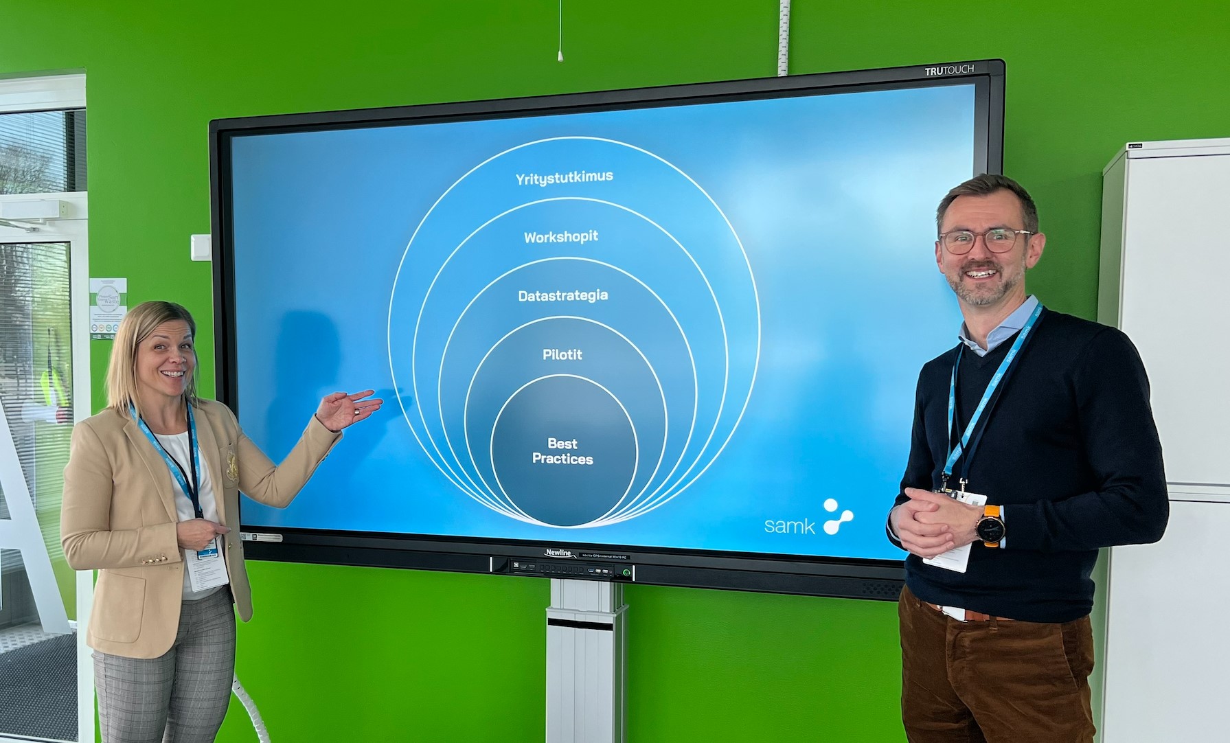 Woman and a man presenting a chart.