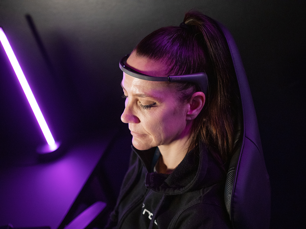 The female subject is wearing a device that measures EEG waves in her head.