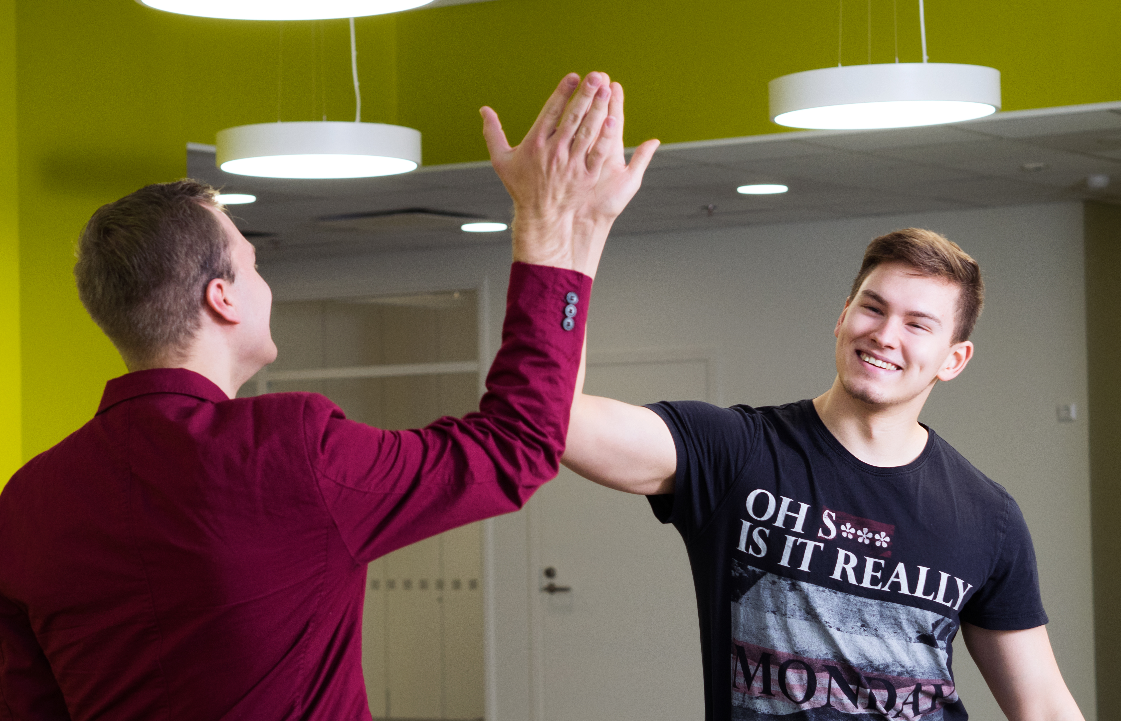 Students at campus highfiving