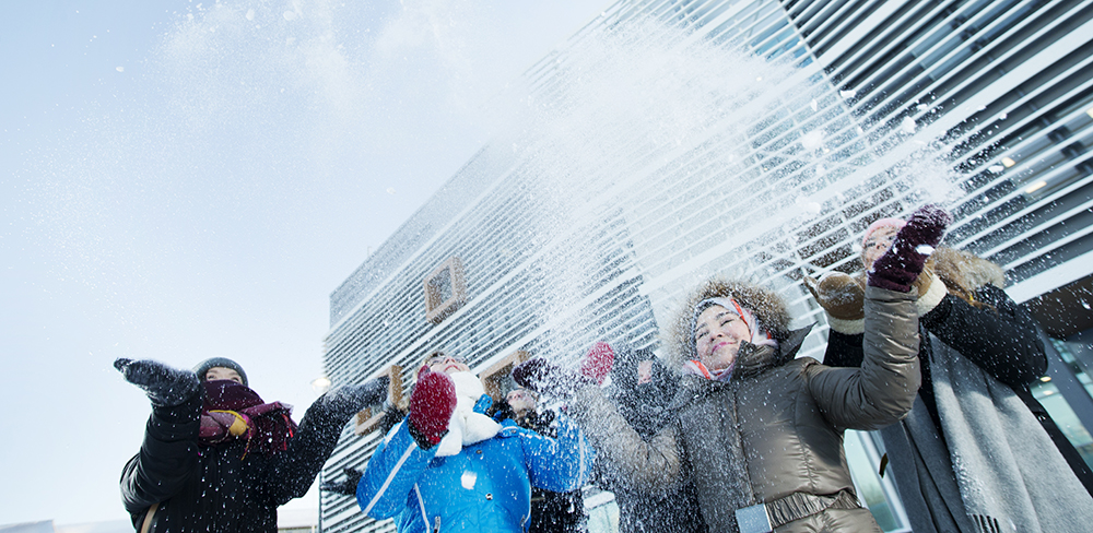 Opiskelijoita heittelemässä pakkaslunta. SAMK students playing with snow.