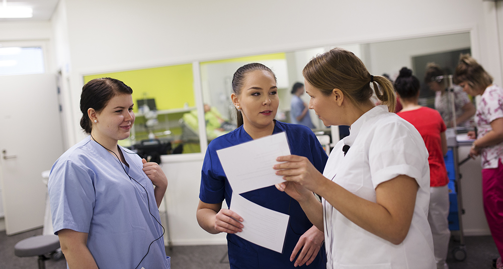 Nursing students in nursing simulation room.