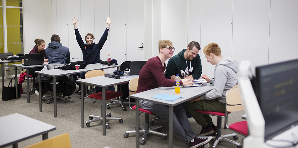 Happy technology students studying English.