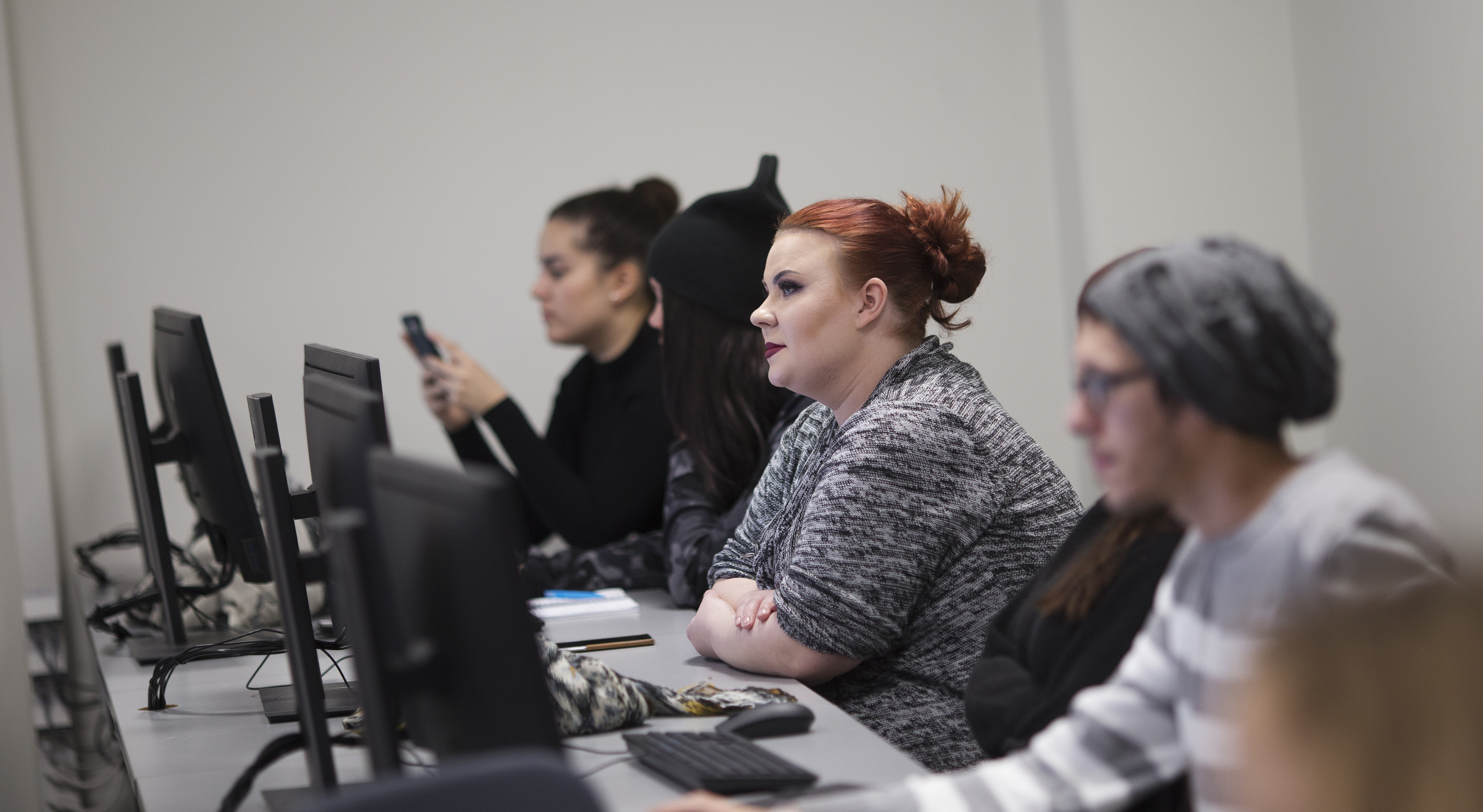 Students of Hospitality Management working with computers in a classroom.