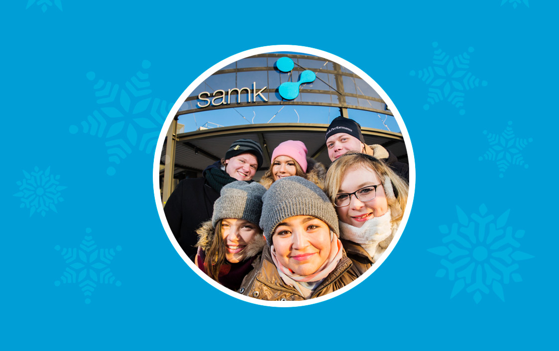 Happy students a front of campus at season's greetings card.