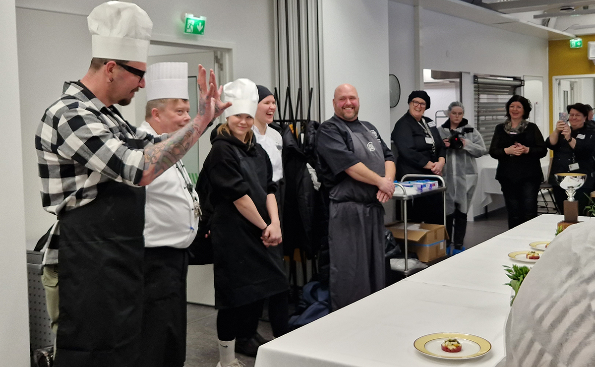 Ruokakilpailun voittajajoukkue esittelee annostaan.