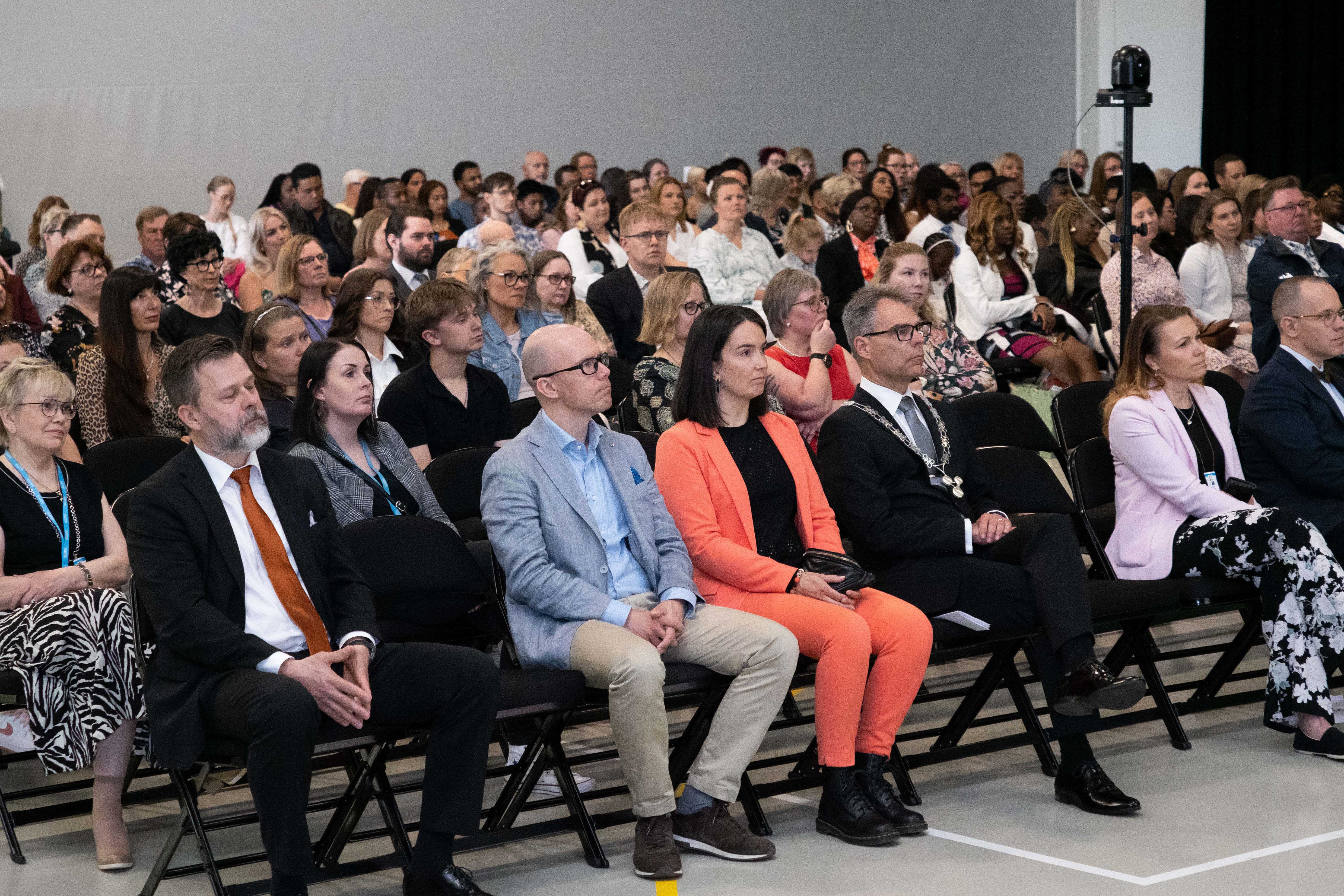 The audience of the event sitting at the Agora hall.