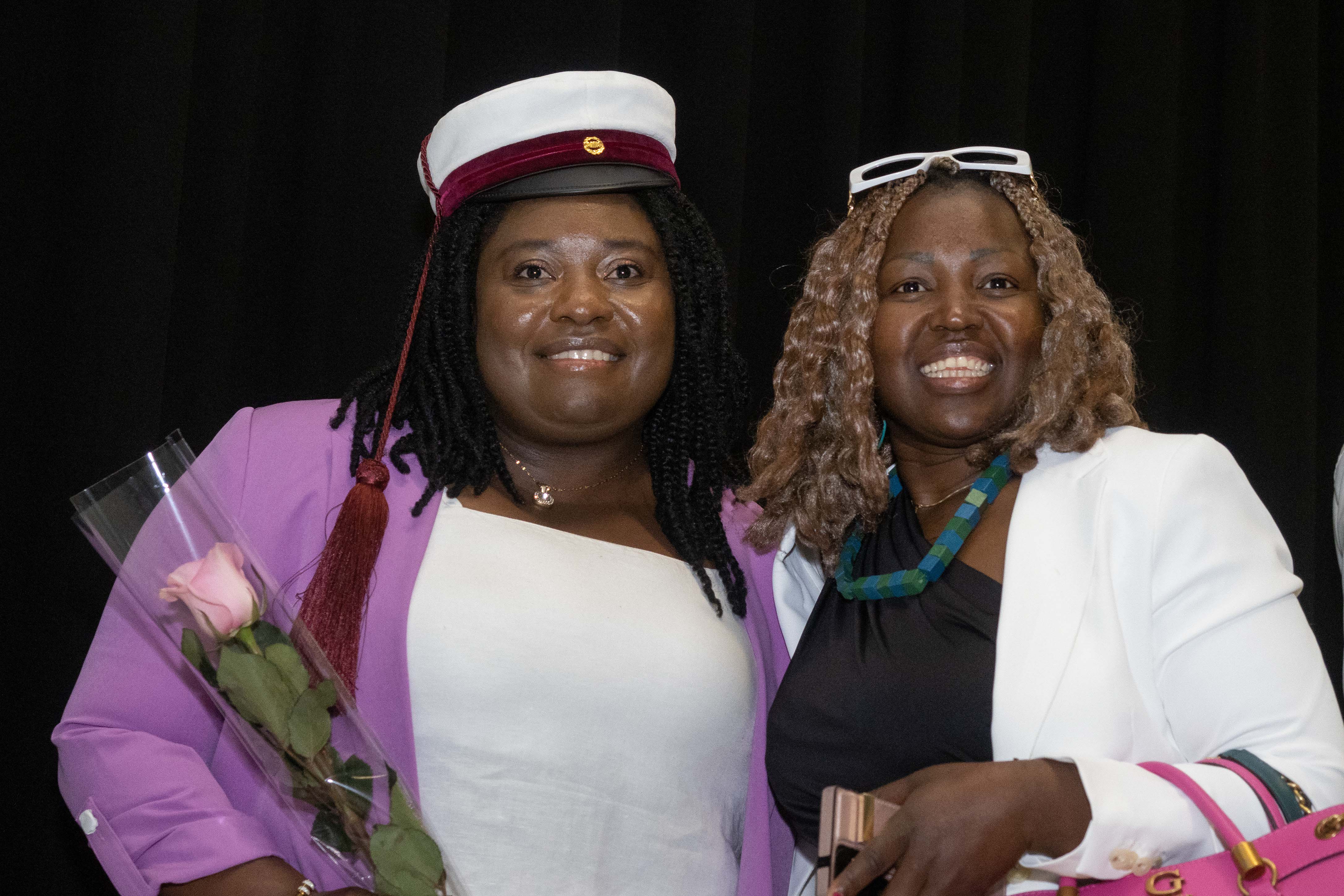 Close-up of two graduating students.