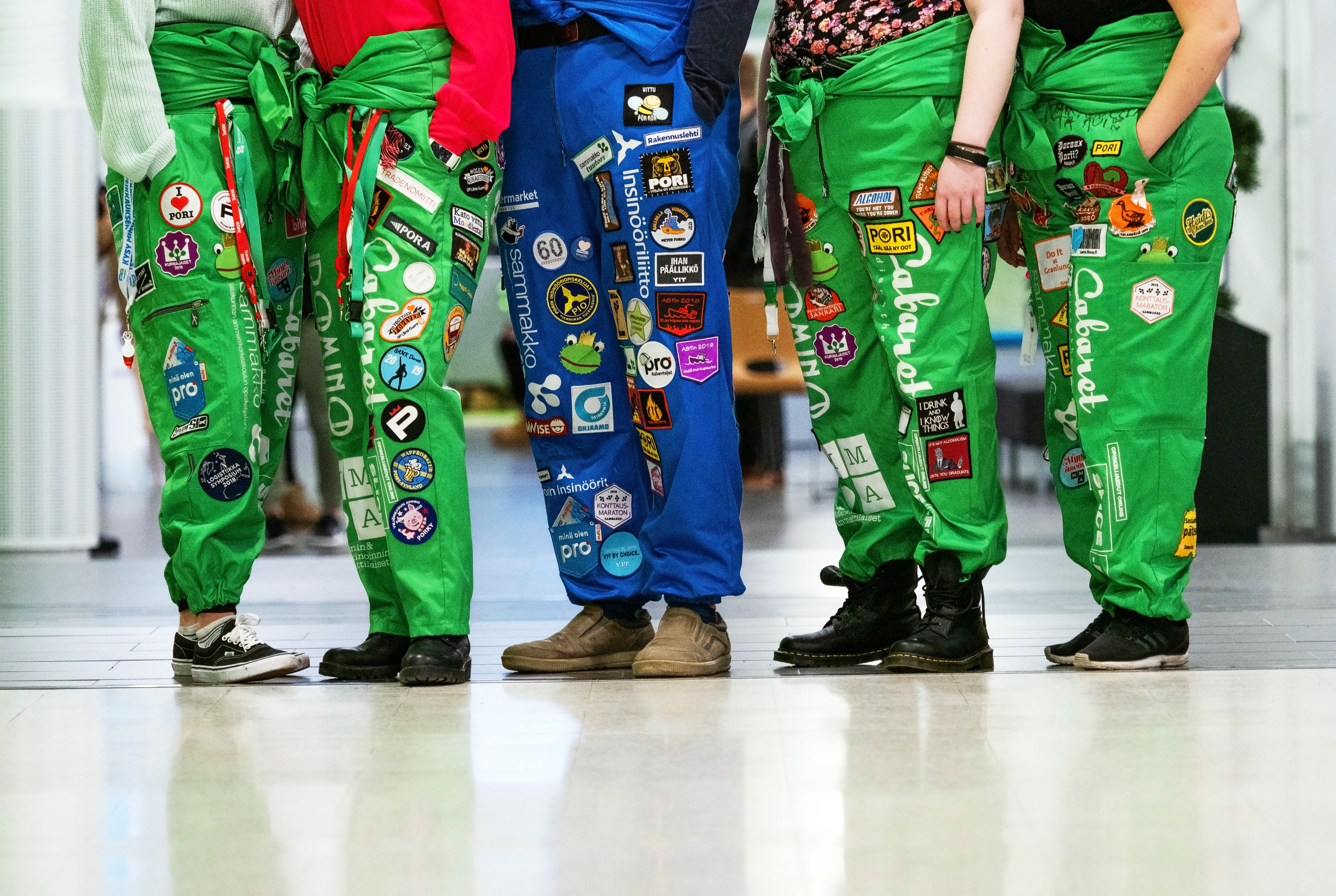 Students' feet with student overalls on.