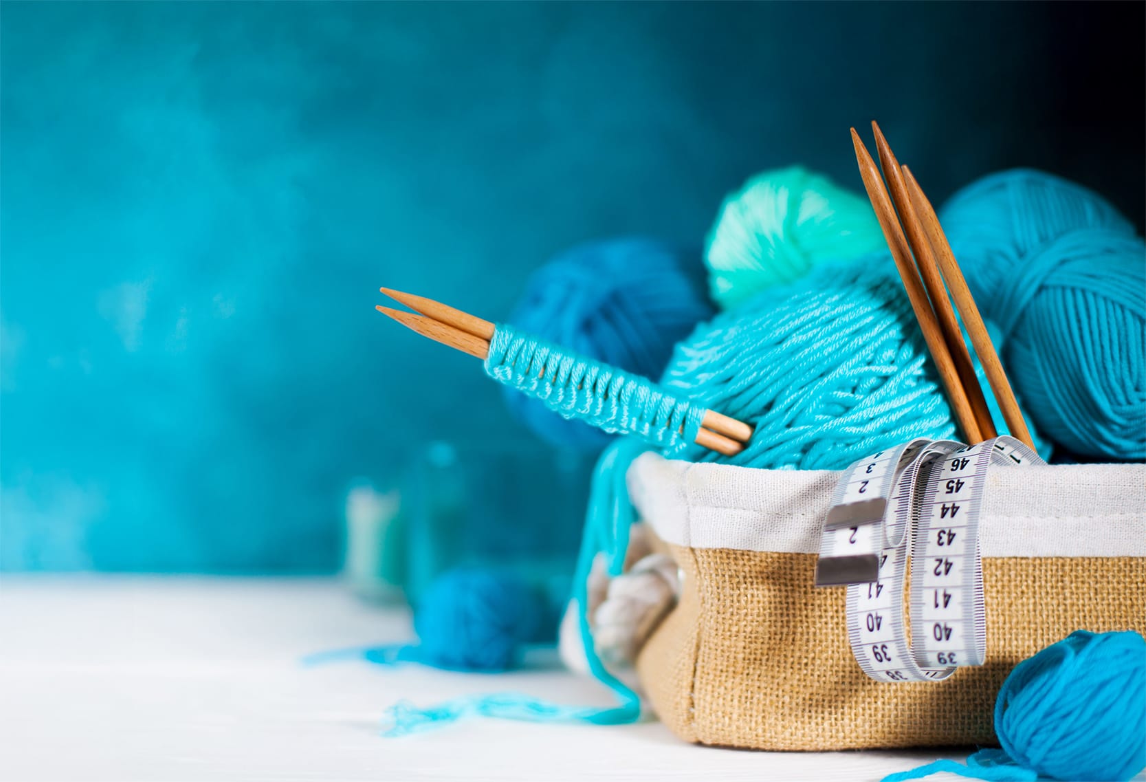 Turquoise wool balls in a basket.