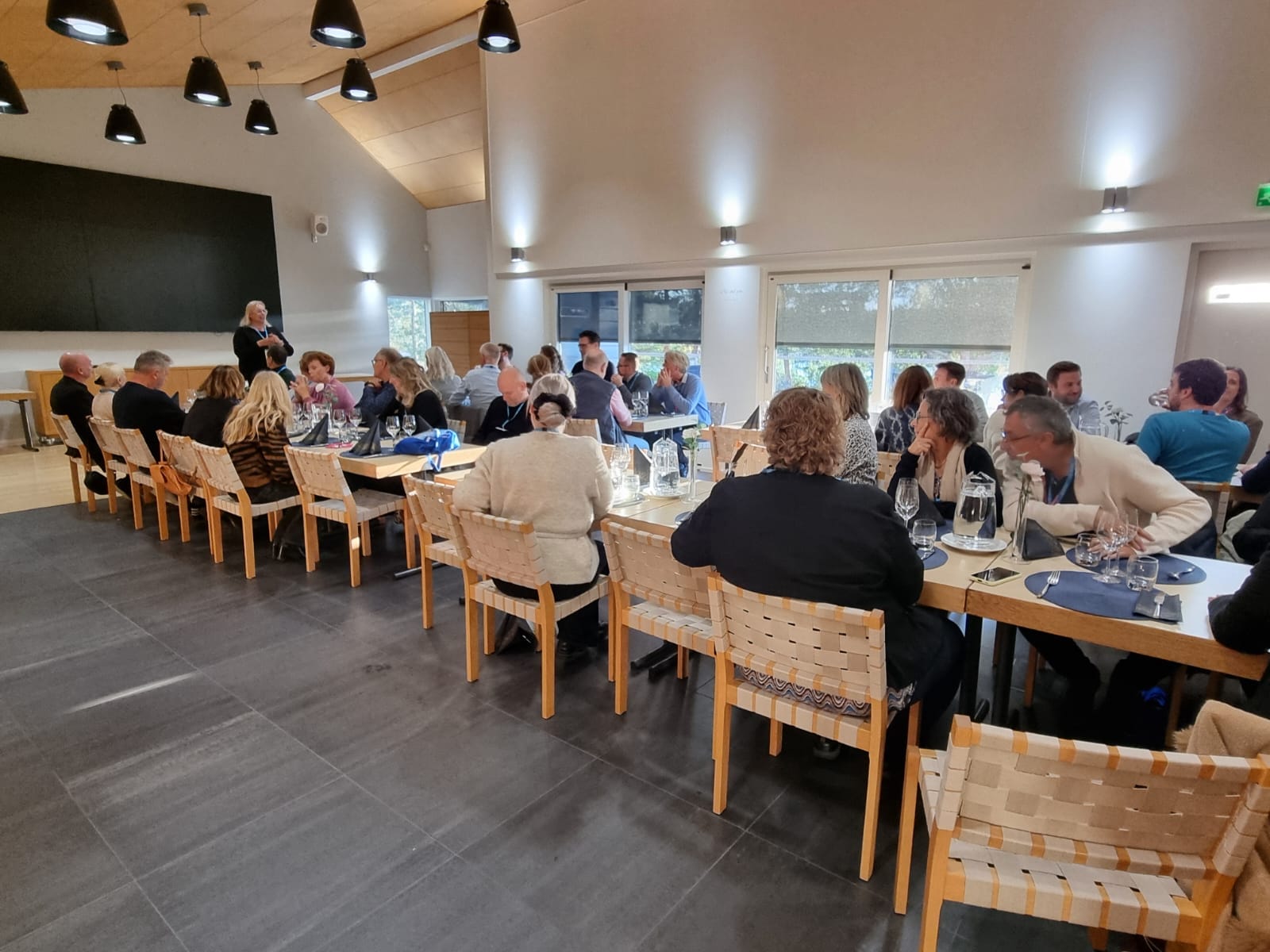 Conference participants sit in the auditorium and listen to the presentation.