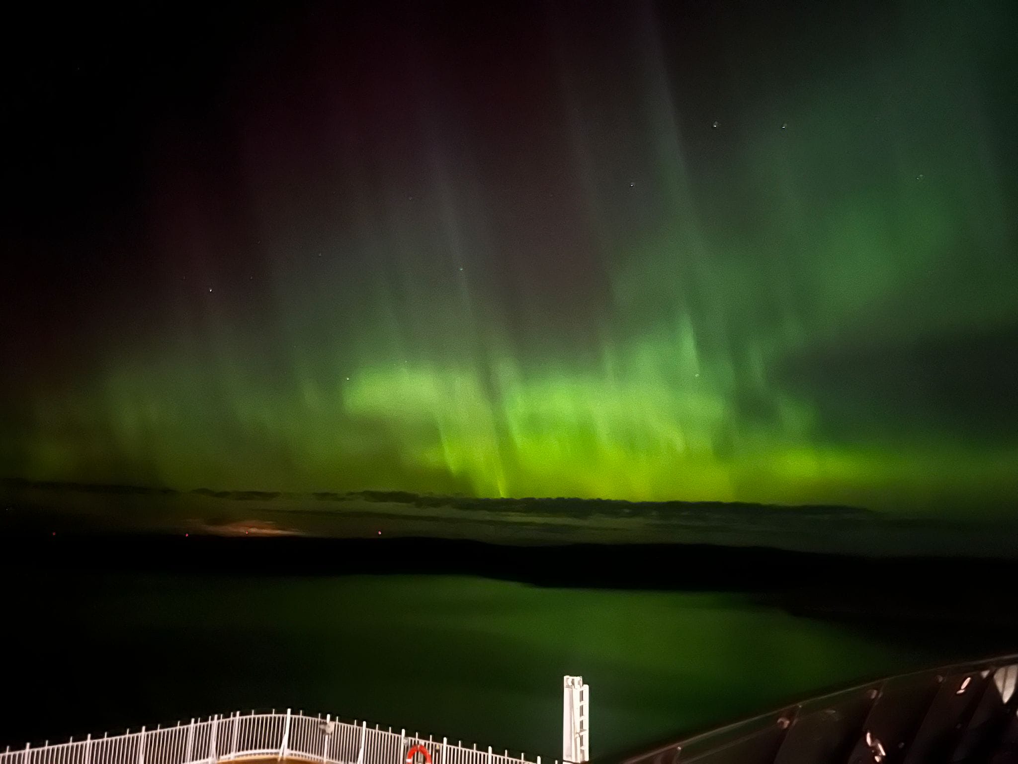 Northern lights photographed from the deck of a ship.