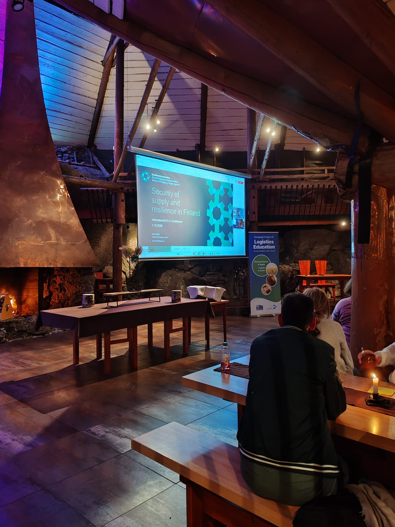 The audience sits by the fireplace and listens to the performance.