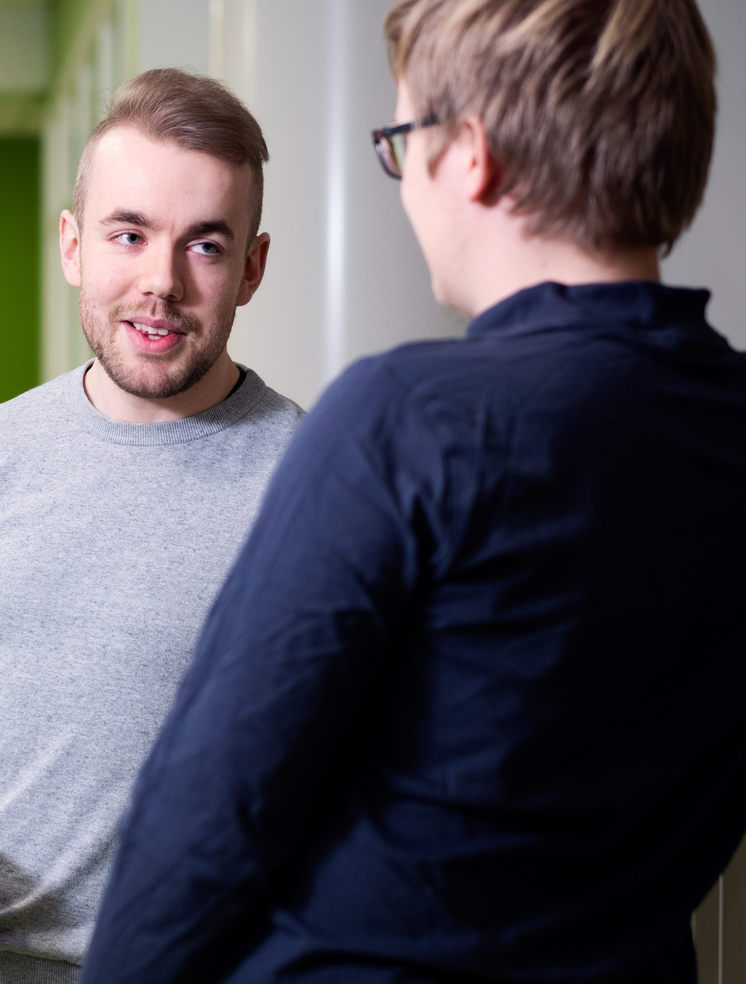 Two students talk on campus.