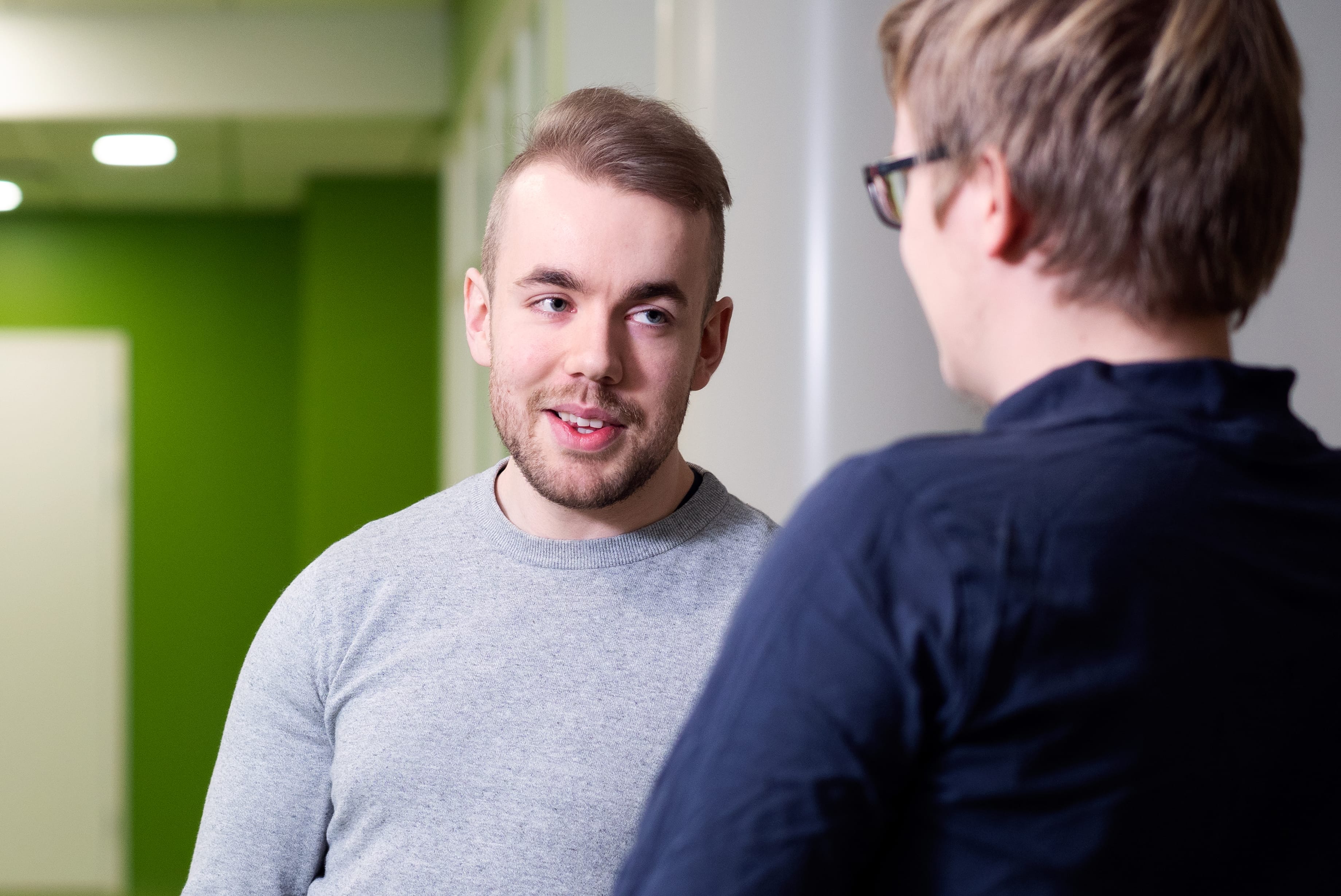 Two students talk on campus.