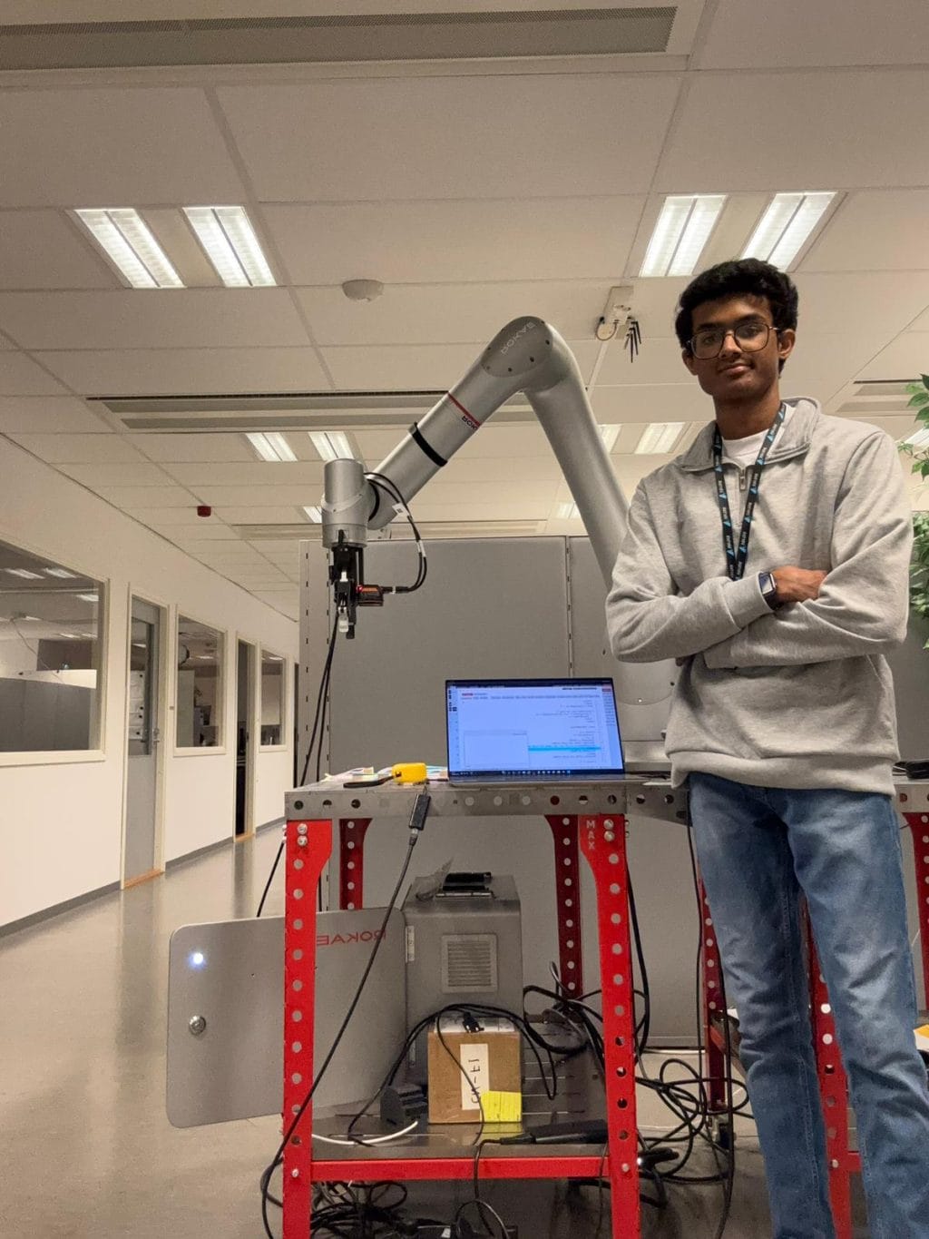 Ganesh posing with a robot