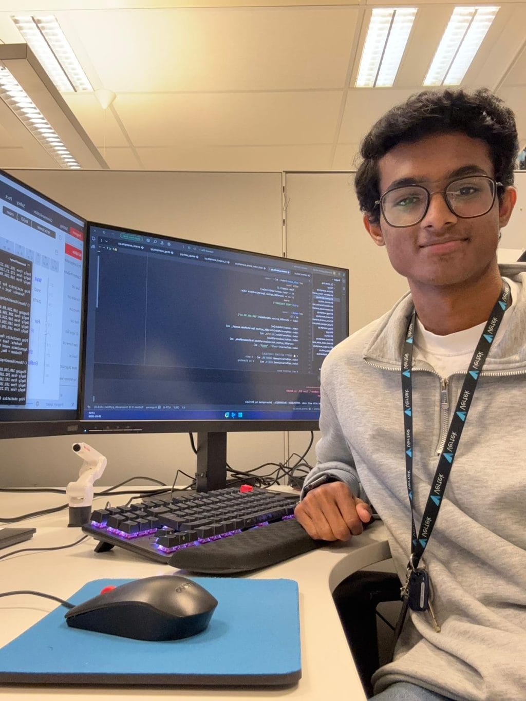 Ganesh working at his desk and with robots at Vertek.