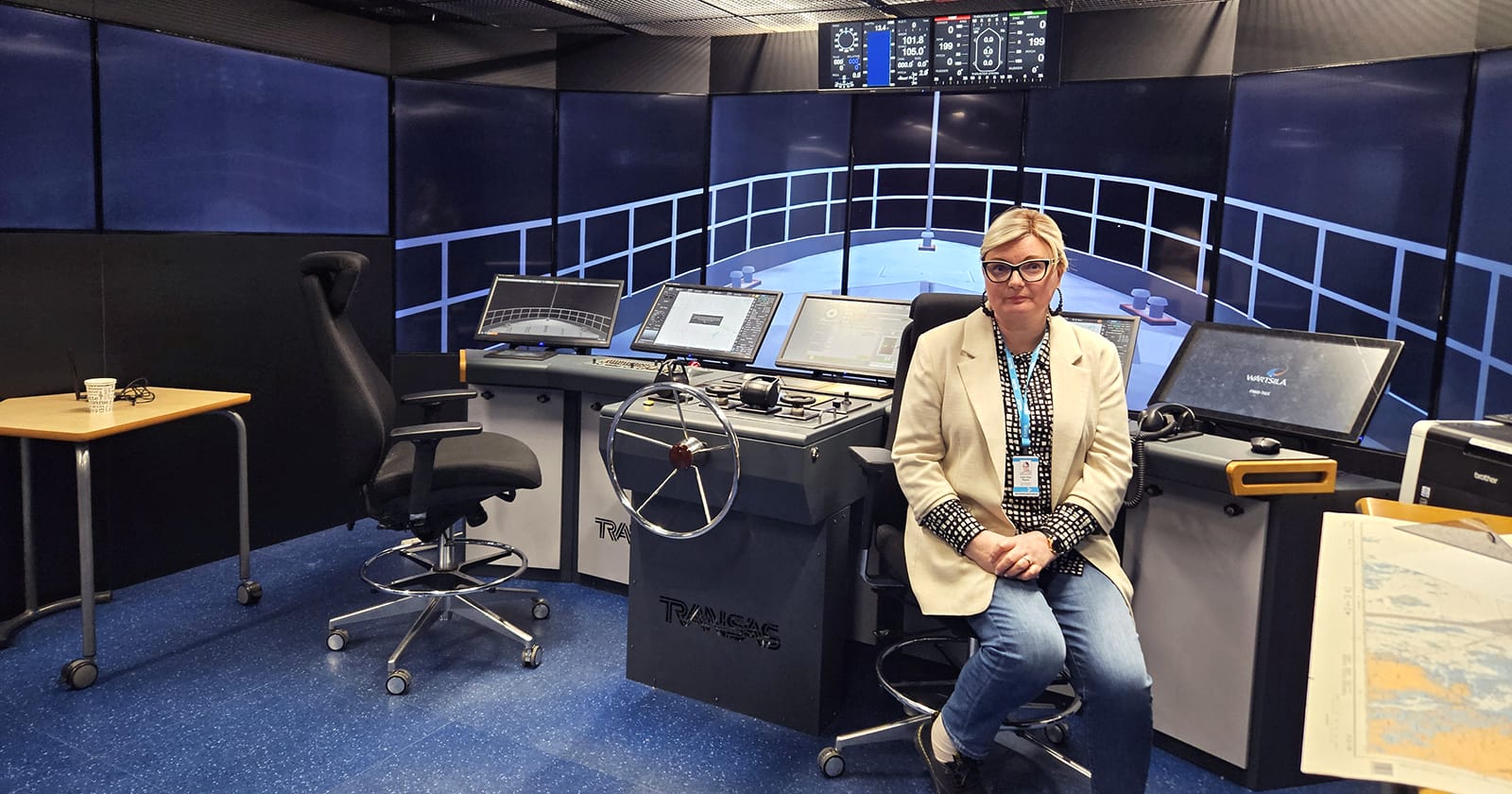 Katri-Piia Rajala is sitting on a chair on the bridge of a maritime simulator.